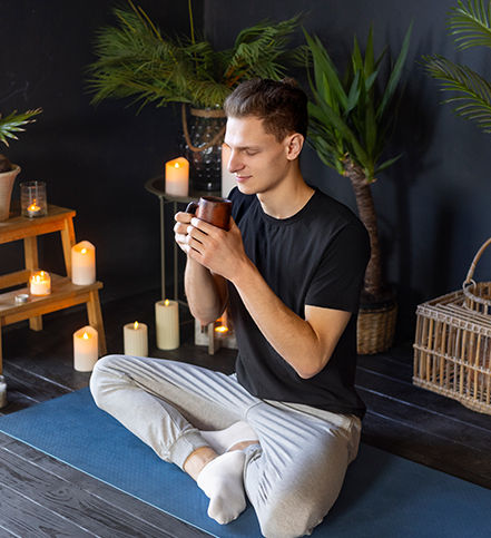 Man practicing mindfulness while enjoying herbal tea